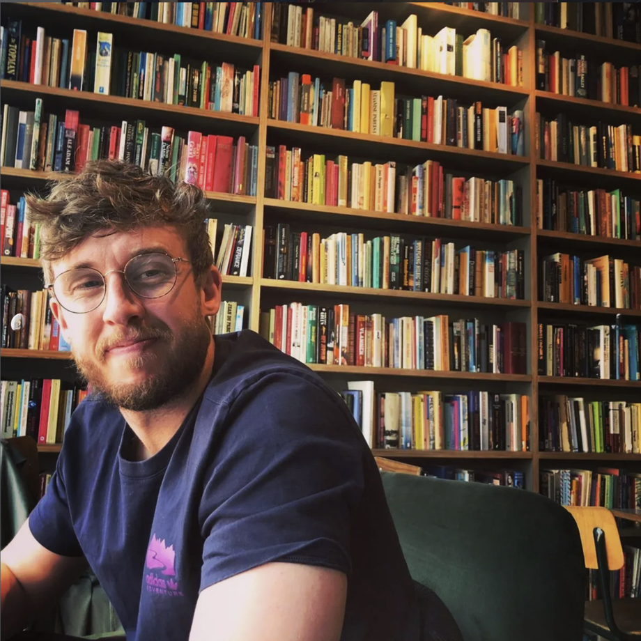 Graeme Whiles at his desk in front of a bookshelf